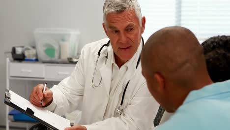 male doctor discussing medical report with patient