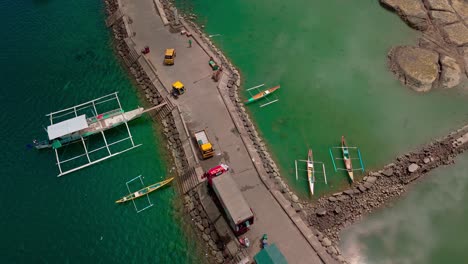 Aerial-Shot-of-Vibrant-Port-of-Placer,-Philippines-with-Boats-and-Vehicles