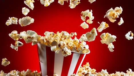 popcorn falling into a bucket of popcorn on a red background