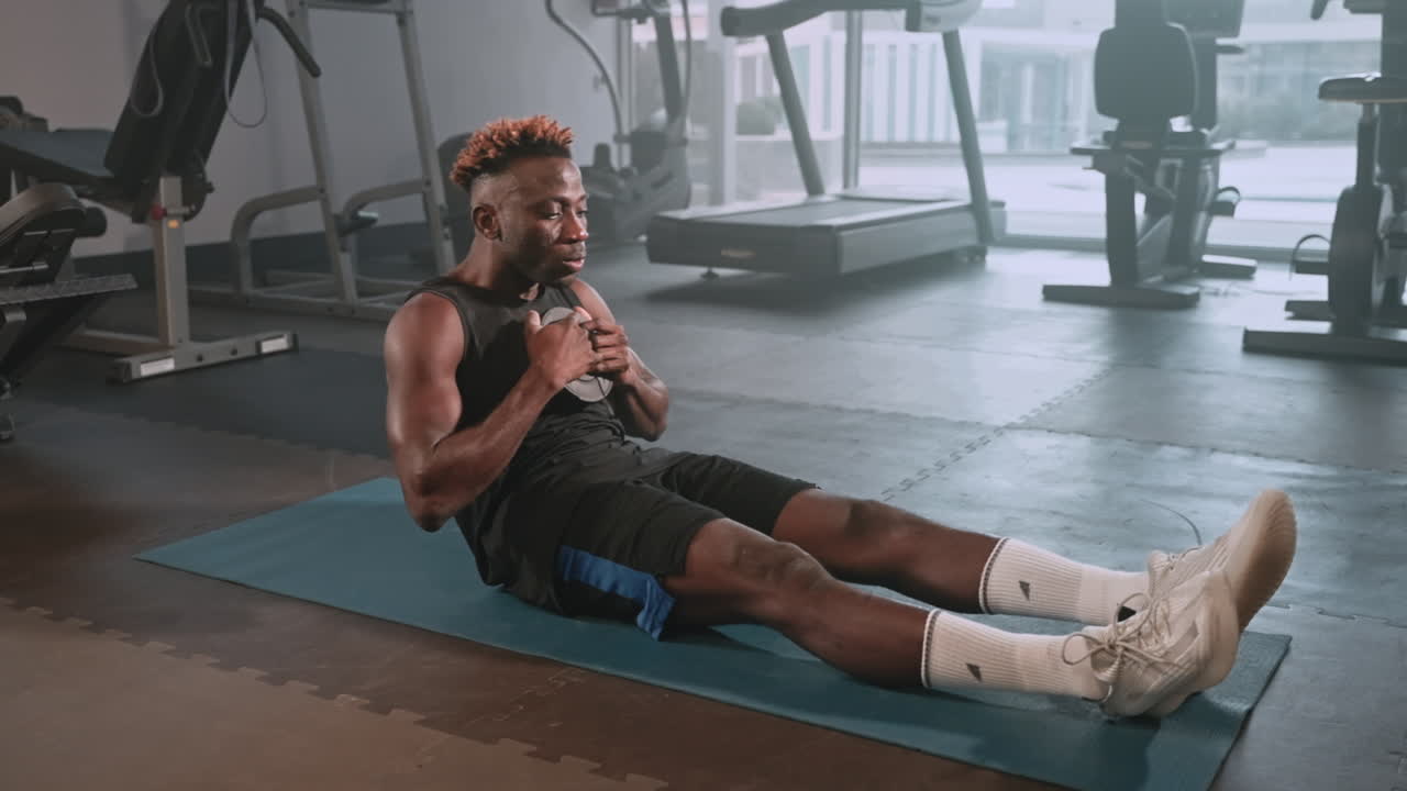 Man Doing Sit-Ups in a Gym