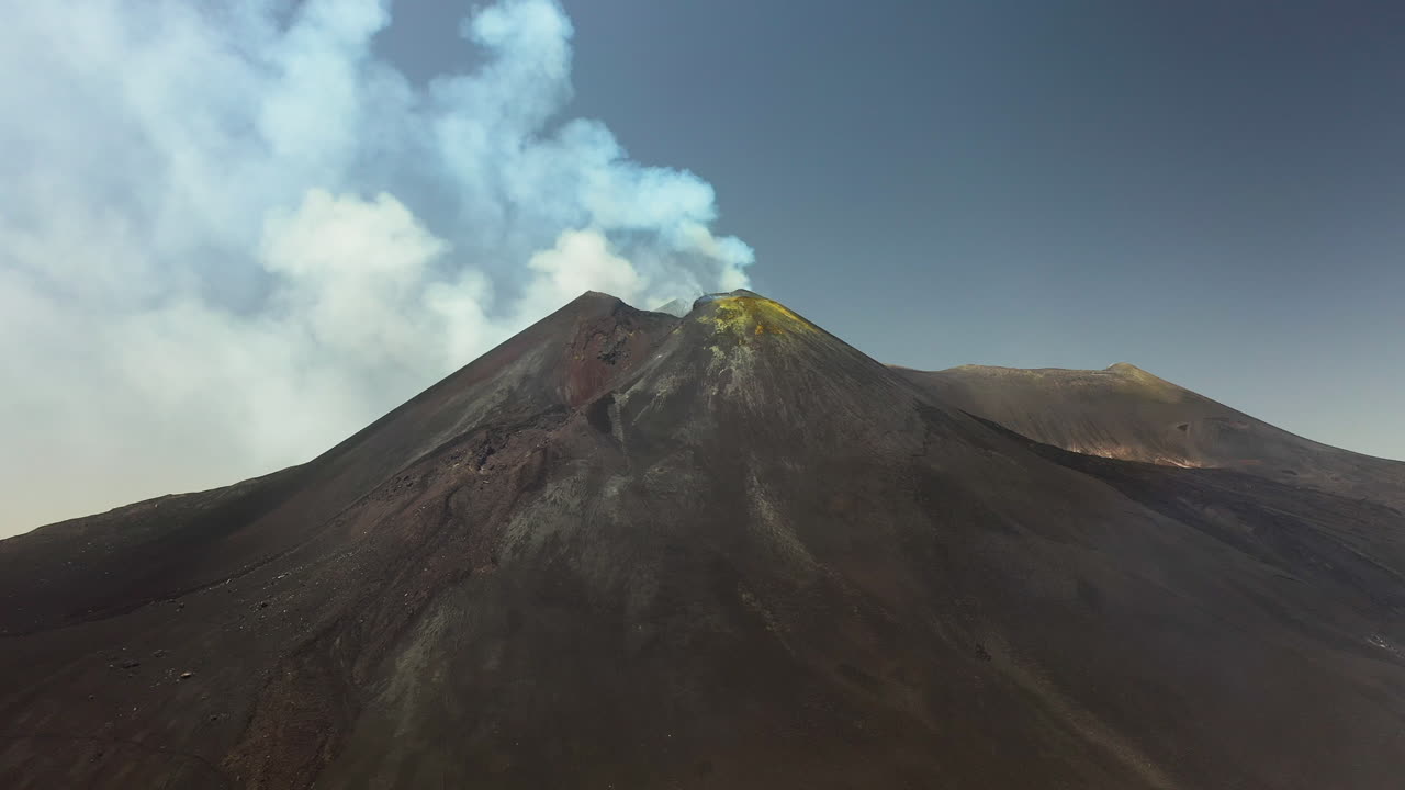 toma aérea giratoria del monte etna con humo o vapor saliendo del volcán activo en sicilia italia
