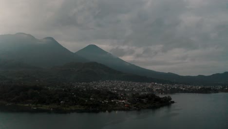 panoramic view of santiago atitlan village in guatemala at sunrise - aerial drone shot