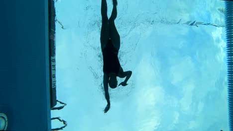 Cinematic-Underwater-Slow-Motion-shot-of-a-female-swimmer-swimming-through-her-lane