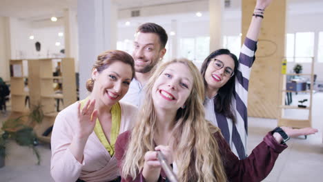 office team takes a selfie with a stick