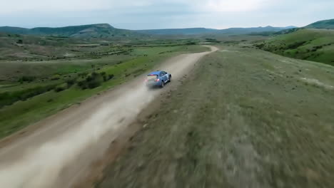 aerial view of rally car on a dirt road