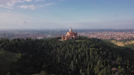 drone shot looking over santuario della madonna di san luca onto bologna