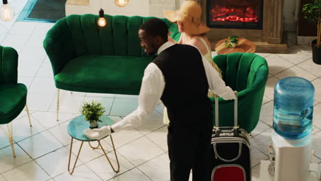 bellboy helping guest to carry baggage