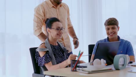 Group-meeting-of-creative-business-people,-designer-and-artist-at-office-desk.