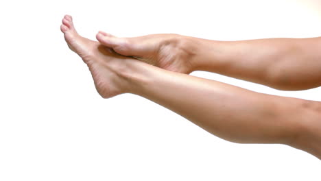 close up on smoth woman legs with healthy skin over white background