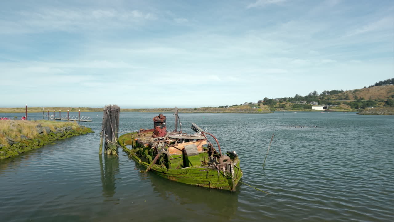 Mary D. Hume shipwreck, rusty old steamer boat on Gold Beach, Oregon, low drone orbit
