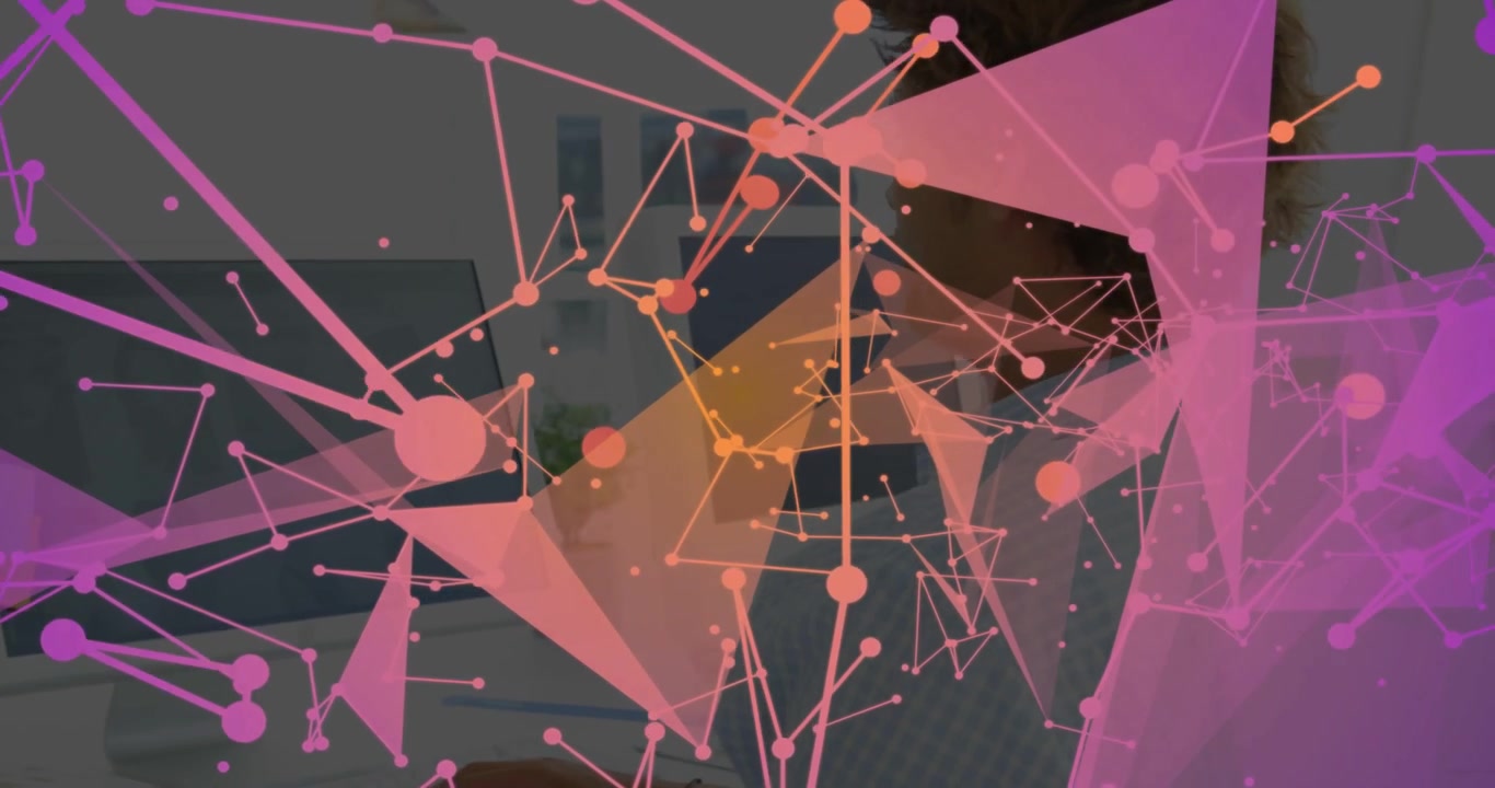 Man sitting desk computer starting pink triangular network mapping data obscuring revealing face