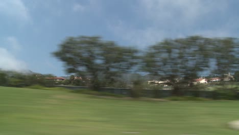 a car travels along pacific coast highway as seen through the side window 7