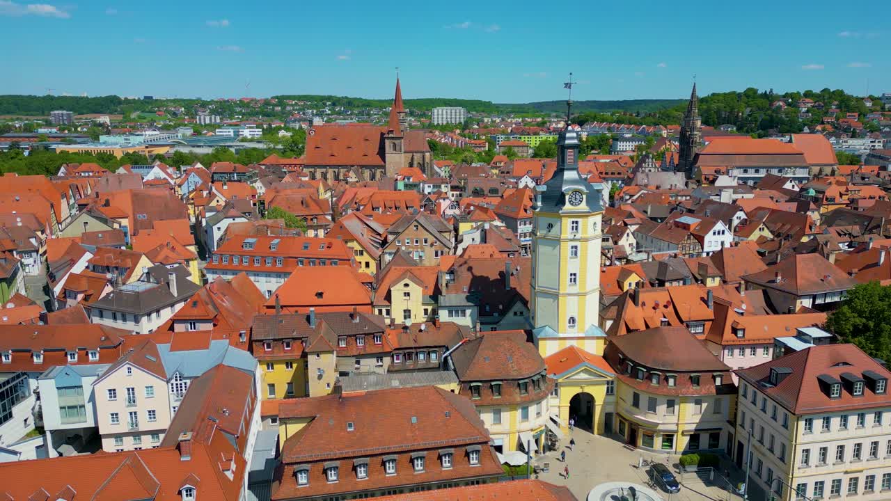 4K Aerial Drone Video of the Historic Herrieder Clock Tower, St. Johannis Church, and St. Gumbertus Church in the Old Town area of Downtown Ansbach, Germany