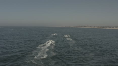 Beautiful-aerial-drone-of-California-coastal-beach-with-Jetski---Ungraded