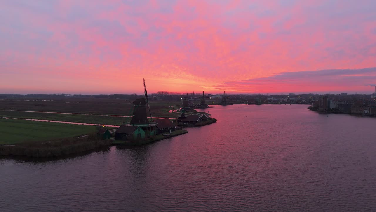 Dronevideo of the Windmills of zaanse schans (close to Amsterdam) in the early dawn lights.