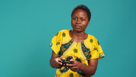 Joyful-gamer-girl-celebrating-her-videogames-win-against-blue-background