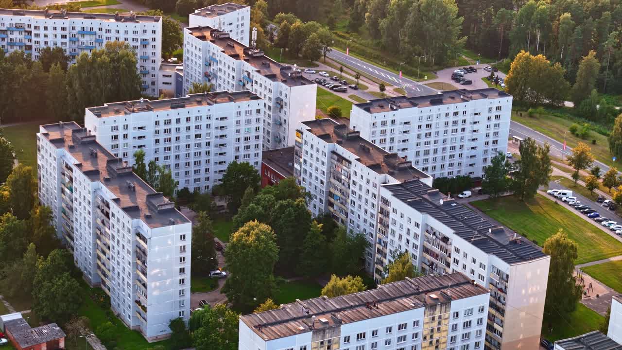 Soviet-era apartment buildings with green courtyard in Jelgava, Latvia in aerial view at golden hour