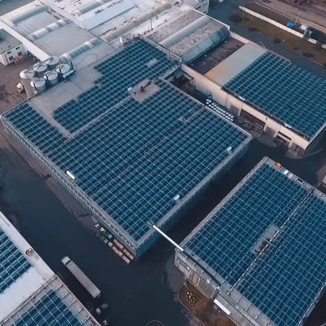 huge solar farm on rooftop of buildings. photovoltaic solar panels receive ecological energy from the sunlight. aerial view.