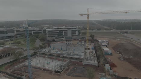 drone aerial of building site with two cranes on site