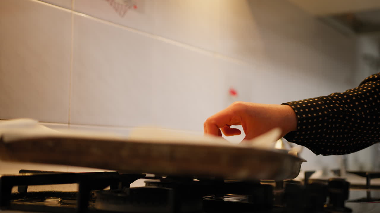 A Woman Hands Are Turning Hot Cookies In The Pan Out Of The Oven