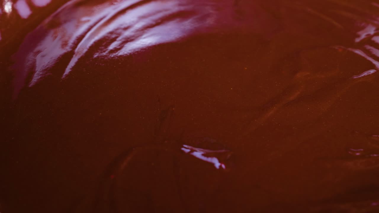 Zuccherini colorati che si spargono su cioccolato liscio