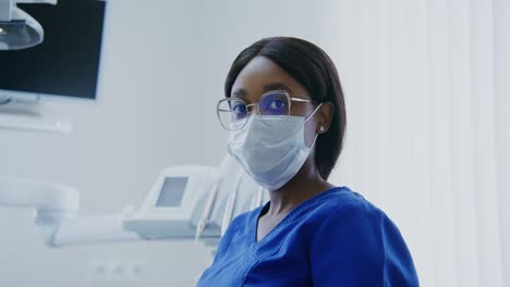 female doctor wearing mask and glasses in a modern medical office