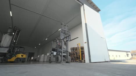 warehousing. forklift driver stacking big bag of raw material in warehouse. many bags of raw materials in the warehouse