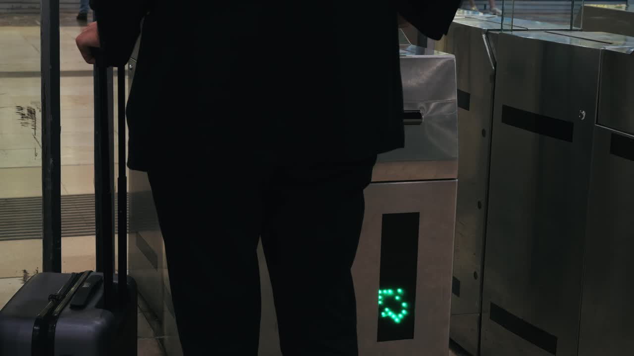 Man with contactless card in metro in Barcelona, hand ticking transport ticket in the machine mobile phone on train station. NFC and contactless technology concept