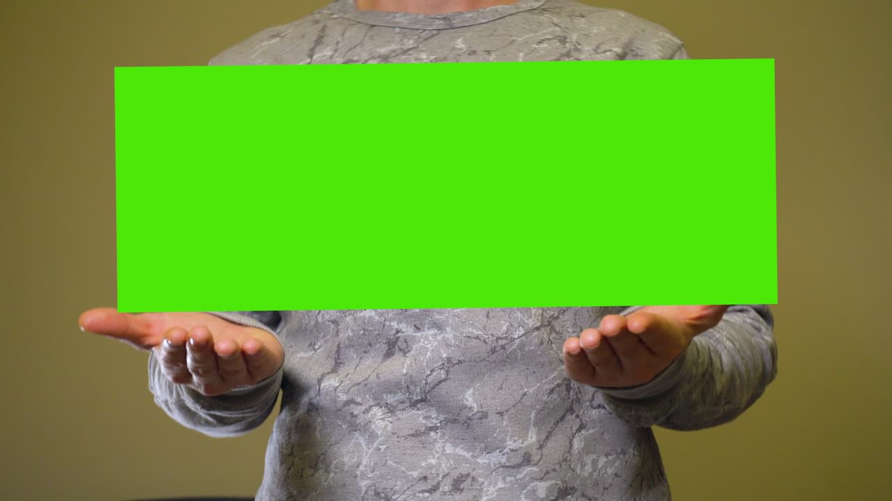 Man raises empty green screen chromakey banner over hands