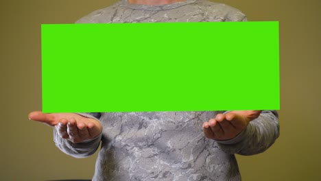 man raises empty green screen chromakey banner over hands