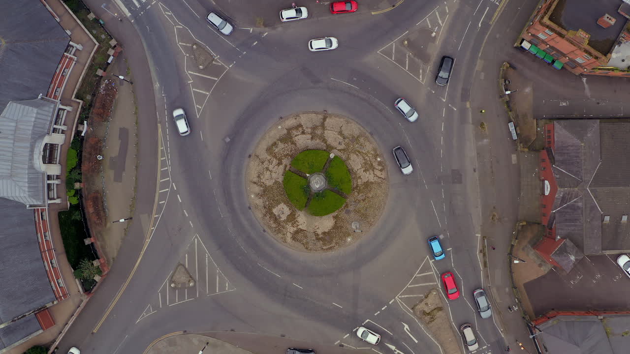 Timelapse of static top-down aerial, capturing hypnotic traffic flow at Belfast roundabout