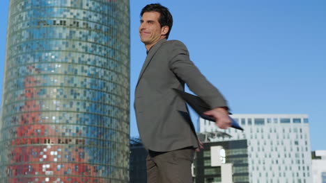 Businessman-celebrating-success-on-urban-street.-Employee-jumping-in-air-outside