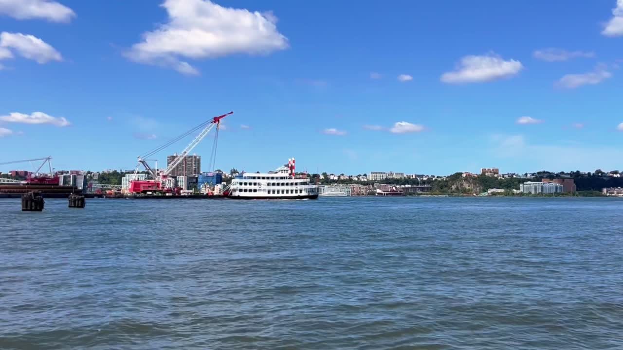 Boat on the River with City Skyline in Background