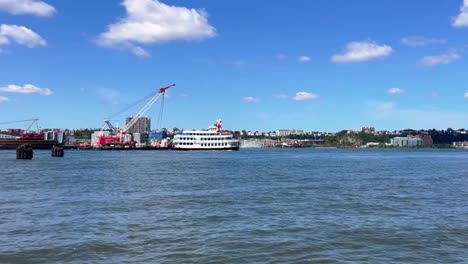 boat on the river with city skyline in background
