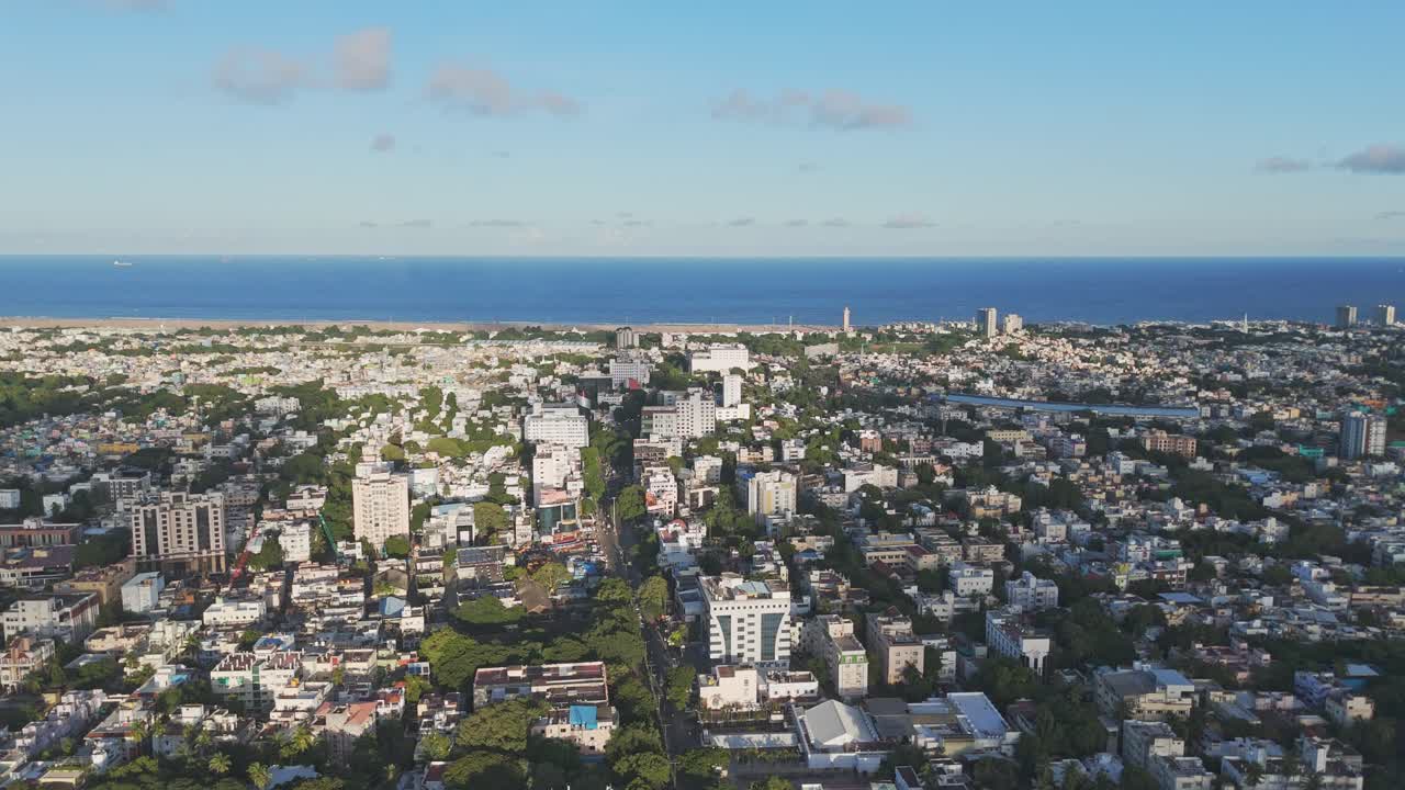 A breathtaking aerial video captures Chennai city bathed in the golden hues of sunset. From a bird's-eye view, the city's sprawling urban landscape unfolds residential area, Beach and Sea