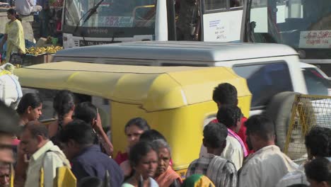 chaotic and busy street with vehicles pedestrians and vendors