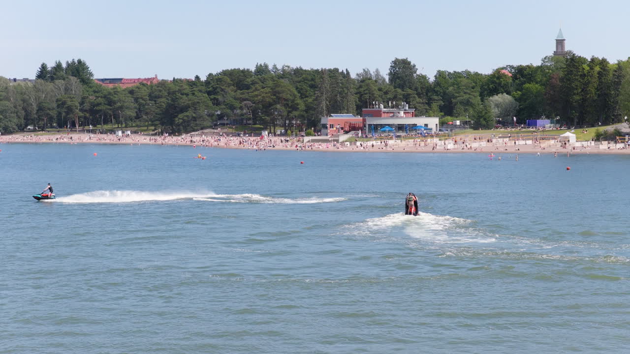 Drone shot of a water scooter in front of Hietaranta beach, summer in Helsinki
