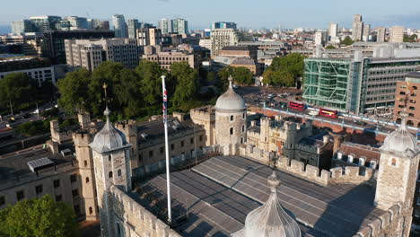 Tilt-and-pan-shot-of-top-of-stone-White-Tower.-Fly-above-historic-landmark-in-Tower-of-London-castle-complex.-London,-UK