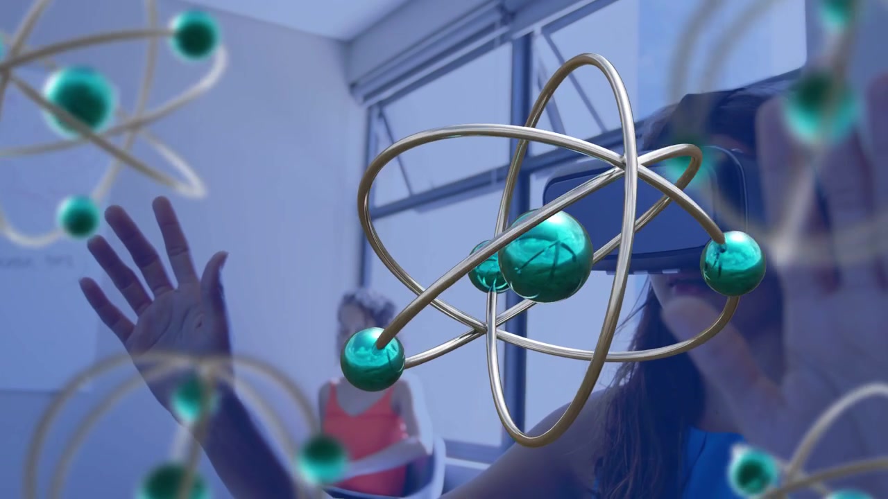 Foreground woman holding device raising hands and pinching, moving ringed teal spheres for training