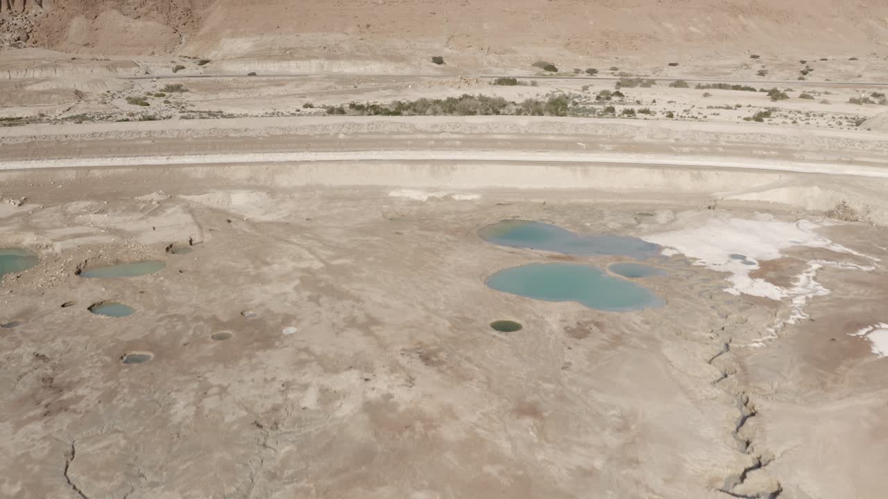 Aerial View of Cracked Earth and Sinkholes in a Desert Landscape