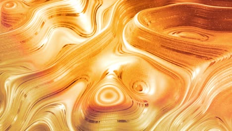 looped abstract background with wavy sparkling golden liquid pattern on shiny glossy surface. viscous yellow fluid like surface of gold foil or brilliant glass. beautiful creative festive backdrop.