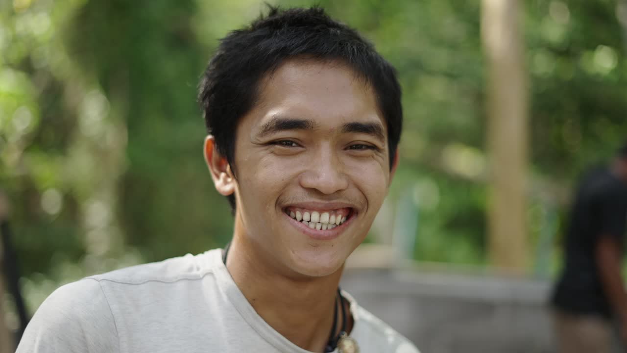 Portrait of a Young Man Smiling and Laughing Outdoors