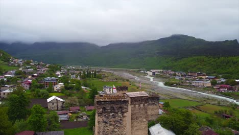 tunning-aerial-shot-of-ancient-Georgian-towers-nestled-amidst-a-scenic-mountain-landscape