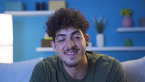 Close-up-portrait-of-happy-and-cheerful-young-man-at-home-at-night.