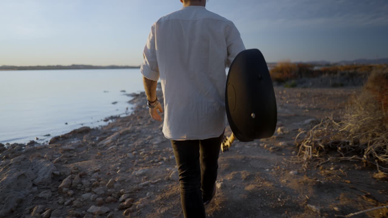 Man with Guitar at Sunset Lake