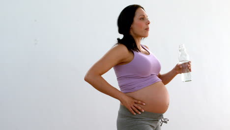 Pregnant-brunette-drinking-water