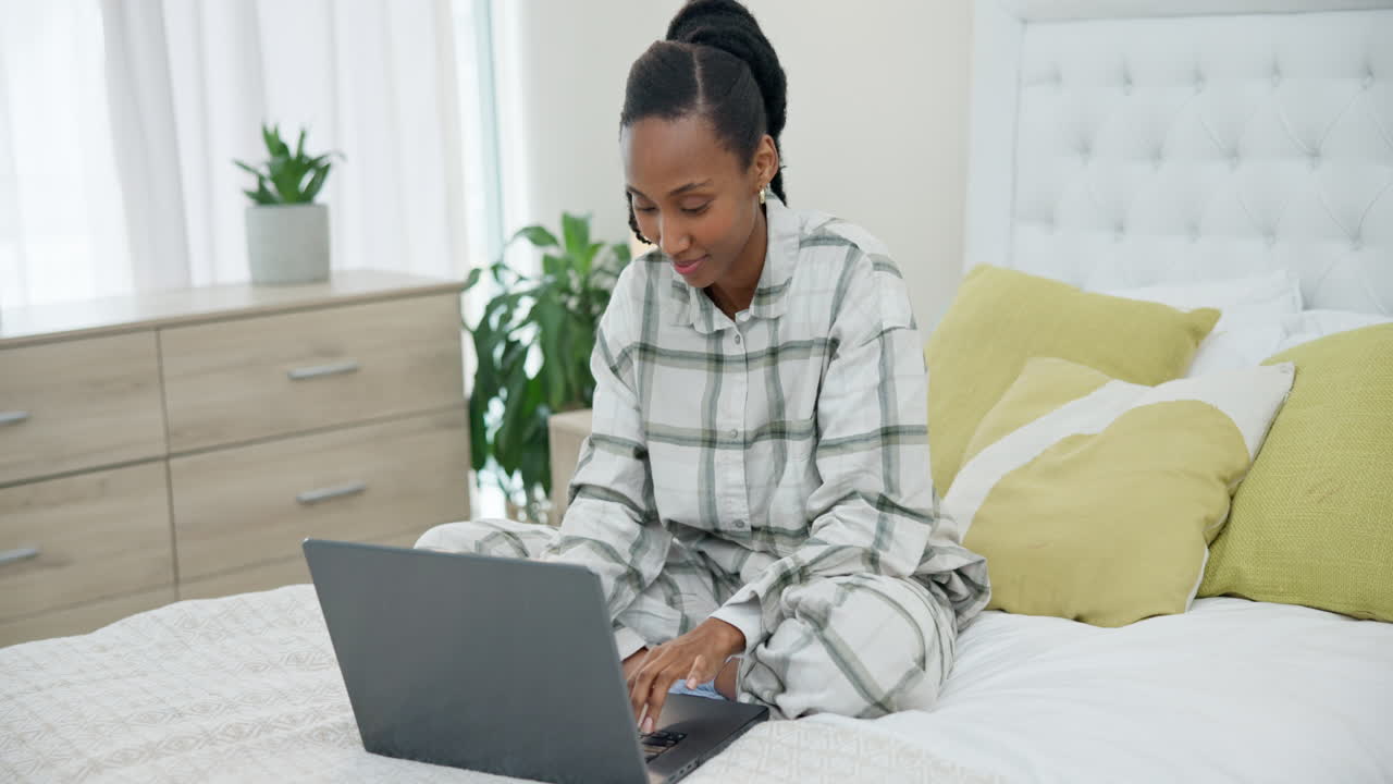 Typing, bed and a black woman with a laptop