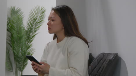 Stressed-Or-Anxious-Woman-At-Work-In-Office-Building-Reacting-To-Internet-Or-Social-Media-News-Message-Or-Story-On-Mobile-Phone-2