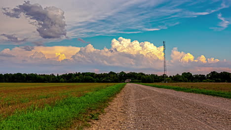 cinematic time lapse footage of dramatic cloud formations with a agricultural field in the foreground