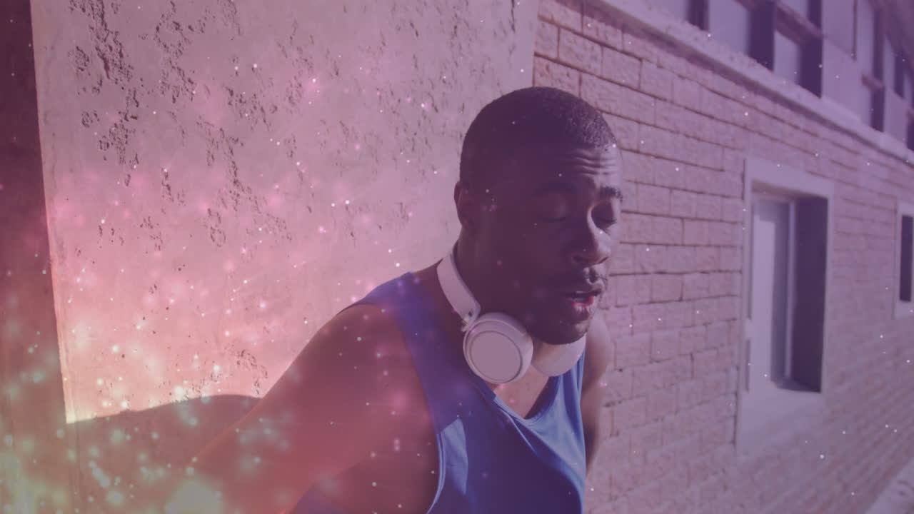 Animation of glowing lights over an exercising african american man
